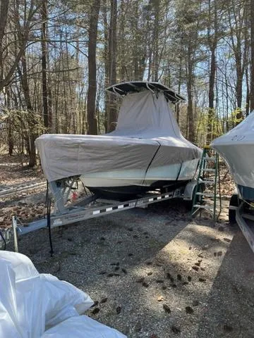 Slide: The Image of 2020 Key West 219fs boat covered and parked on a trailer in a wooded area. - 3