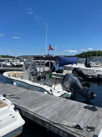 Slide: The Image of 2020 Key West 219fs boat docked at marina under clear blue sky. - 9
