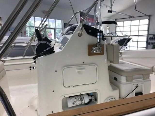 Slide: The Image of 2023 Boston Whaler 170 Montauk boat interior with steering console and storage. - 13