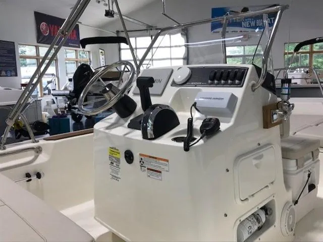 Slide: The Image of 2023 Boston Whaler 170 Montauk boat console with steering wheel and controls. - 14