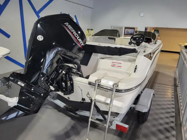 Slide: The Image of 2023 Bayliner Element M17 boat with Mercury outboard motor, displayed indoors. - 10