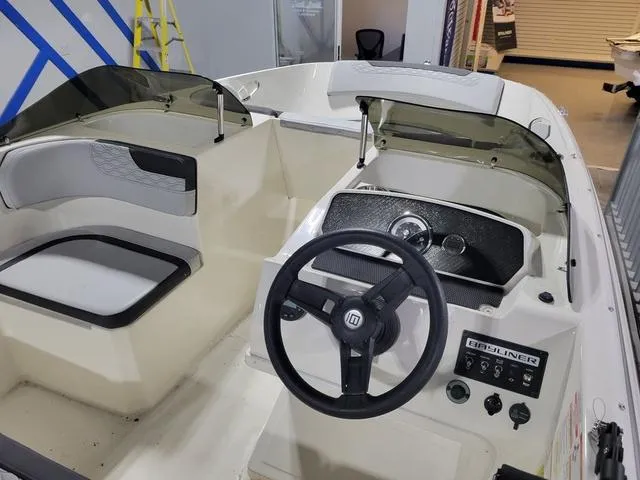 Slide: The Image of 2023 Bayliner Element M17 boat interior with steering wheel and seating. - 11