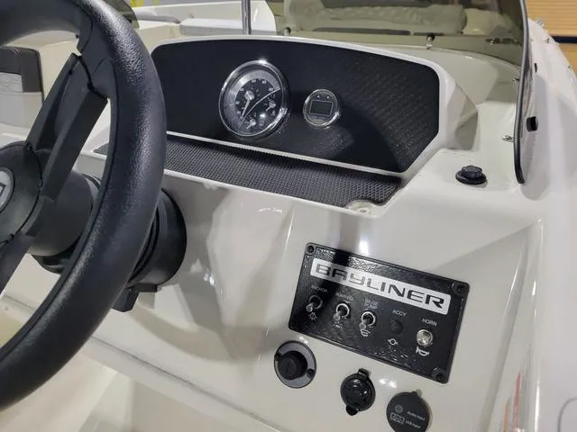 Slide: The Image of 2023 Bayliner Element M17 dashboard with steering wheel and control panel. - 12
