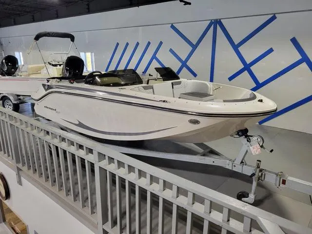 Slide: The Image of 2023 Bayliner Element M17 boat displayed indoors on a trailer. - 14