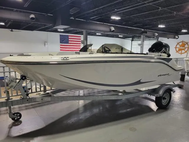 Slide: The Image of 2023 Bayliner Element M17 boat on trailer in showroom with American flag. - 5