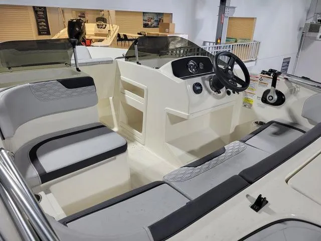 Slide: The Image of 2023 Bayliner Element M17 boat interior with modern seating and steering console. - 8