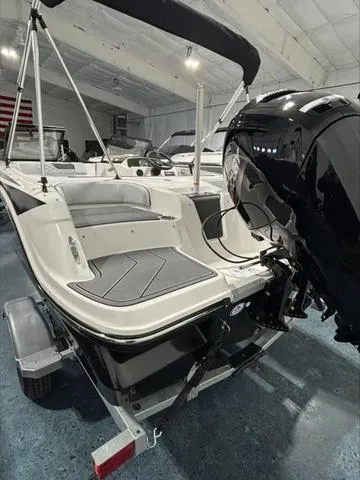 Slide: The Image of 2024 Bayliner M17 boat in showroom, featuring sleek design and powerful outboard motor. - 4