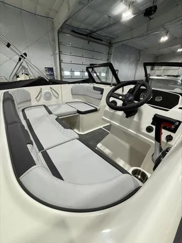 Slide: The Image of 2024 Bayliner M17 boat interior with modern seating and steering wheel in a showroom. - 5