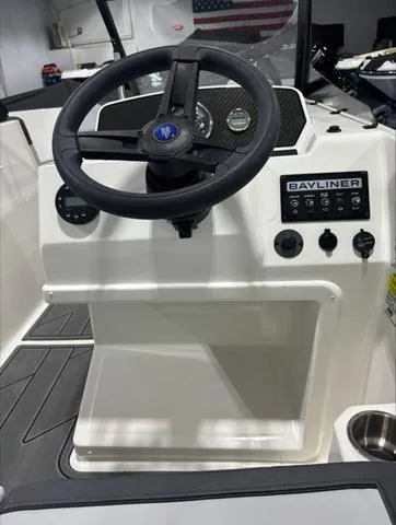Slide: The Image of 2024 Bayliner M17 boat dashboard with steering wheel and control panel. - 6