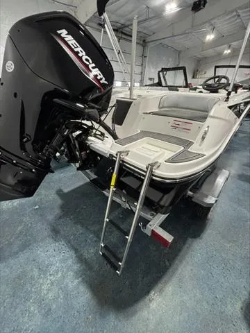 Slide: The Image of 2024 Bayliner M17 boat with Mercury engine, showcased in a spacious indoor setting. - 9