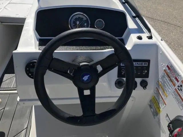 Slide: The Image of 2024 Bayliner M17 boat dashboard with steering wheel and control panel. - 12