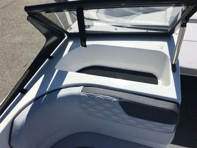 Slide: The Image of 2024 Bayliner M17 boat interior with cushioned seating and windshield detail. - 14