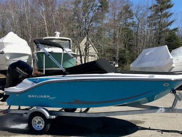 Slide: The Image of 2024 Bayliner M17 boat on trailer, blue hull, parked outdoors. - 19