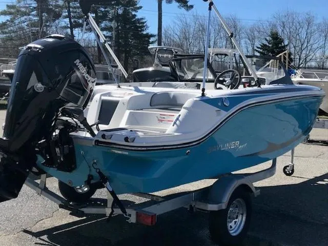 Slide: The Image of 2024 Bayliner M17 boat on trailer, featuring a sleek blue design and powerful outboard motor. - 4