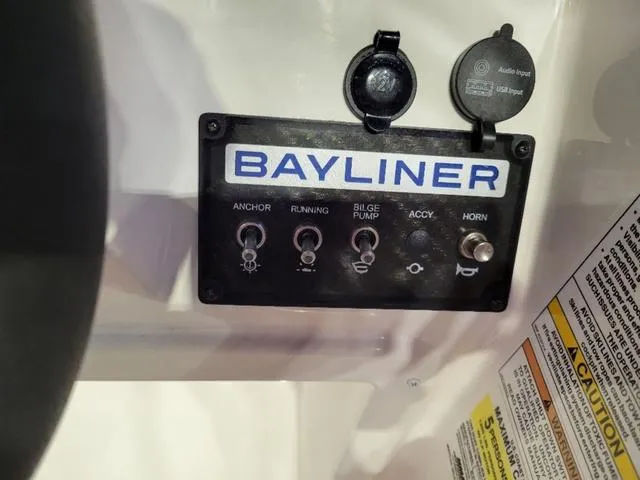 Slide: The Image of Control panel of 2024 Bayliner M15 boat with labeled switches and audio input. - 11