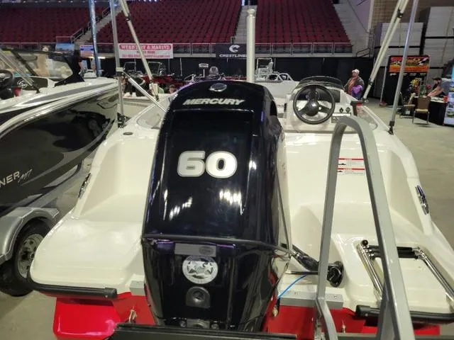 Slide: The Image of 2024 Bayliner M15 boat with Mercury 60 engine displayed indoors. - 4