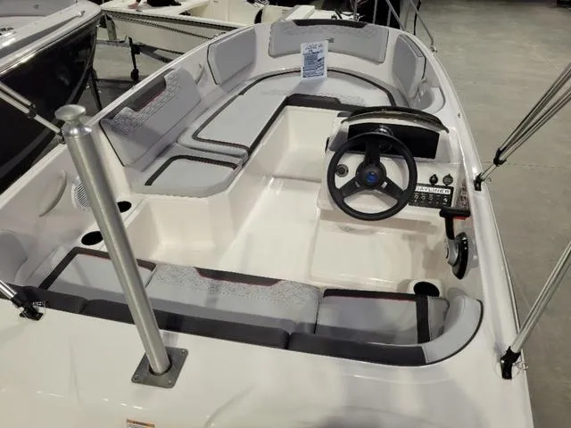 Slide: The Image of 2024 Bayliner M15 boat interior with steering wheel and seating arrangement. - 5