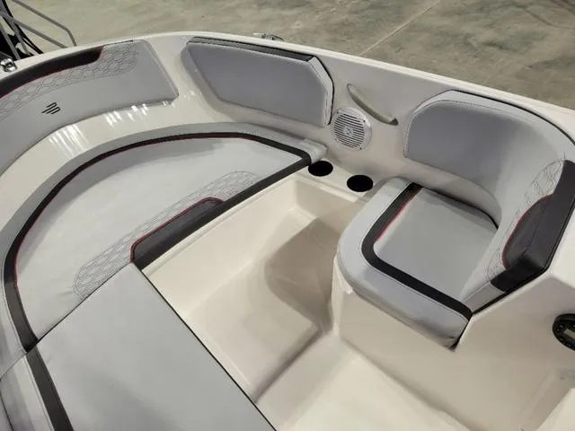 Slide: The Image of 2024 Bayliner M15 boat interior with cushioned seating and cup holders. - 7