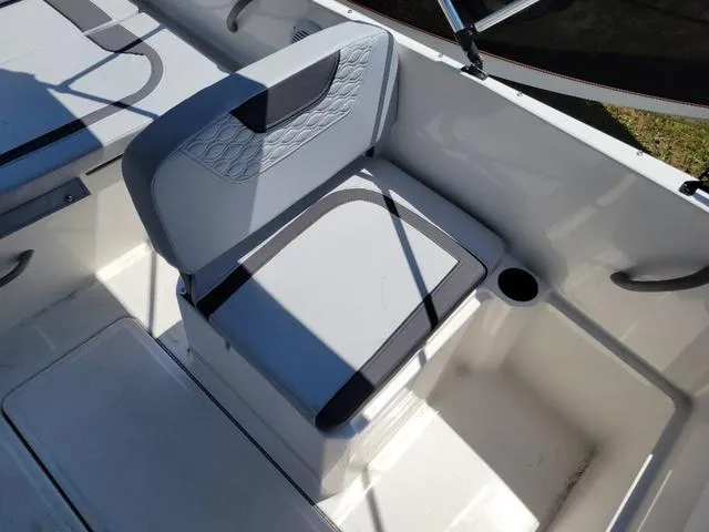 Slide: The Image of 2024 Bayliner M19 boat seat with cup holder, featuring modern design and comfortable upholstery. - 11