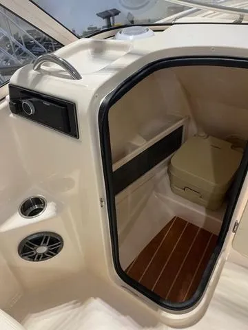Slide: The Image of 2024 Grady-White Freedom 215 boat interior with storage compartment and speaker. - 13