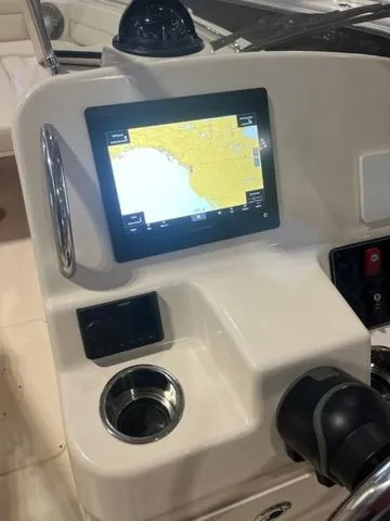 Slide: The Image of 2024 Grady-White Freedom 215 boat dashboard with navigation screen and controls. - 4