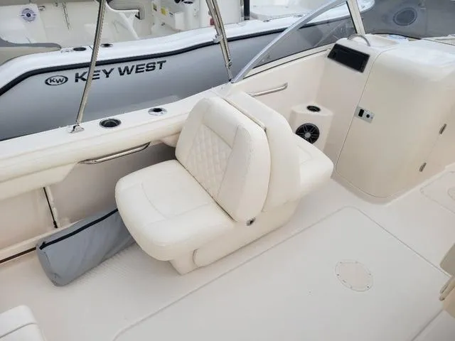Slide: The Image of 2025 Grady-White Freedom 215 boat interior with white seating and sleek design. - 11