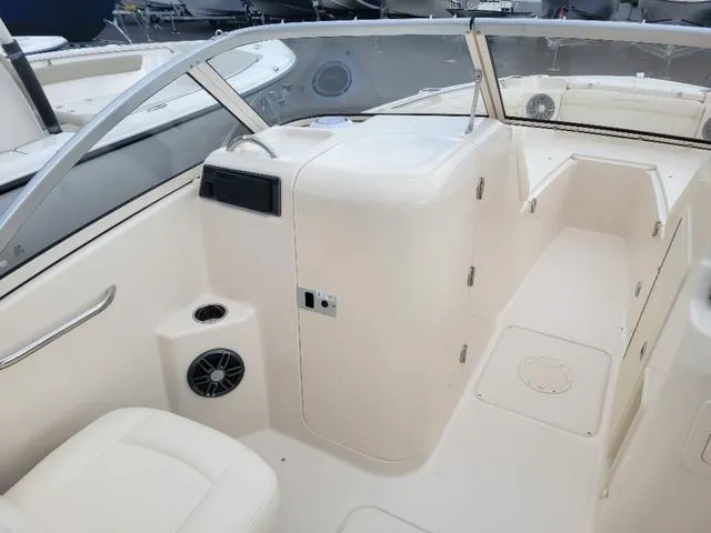 Slide: The Image of 2025 Grady-White Freedom 215 boat interior, featuring seating and control panel. - 12