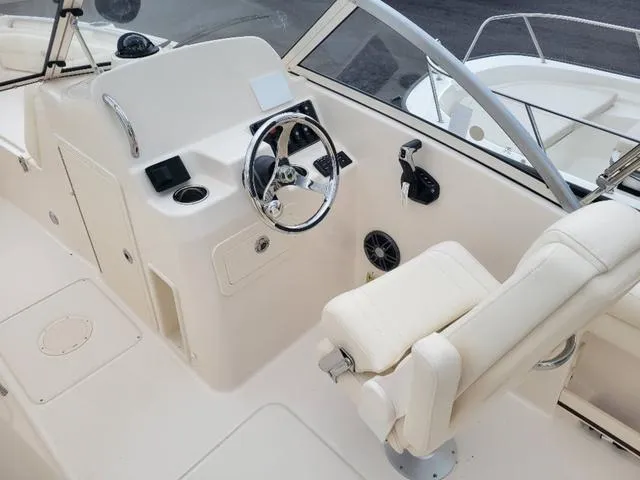 Slide: The Image of 2025 Grady-White Freedom 215 boat interior with steering wheel and seating. - 14