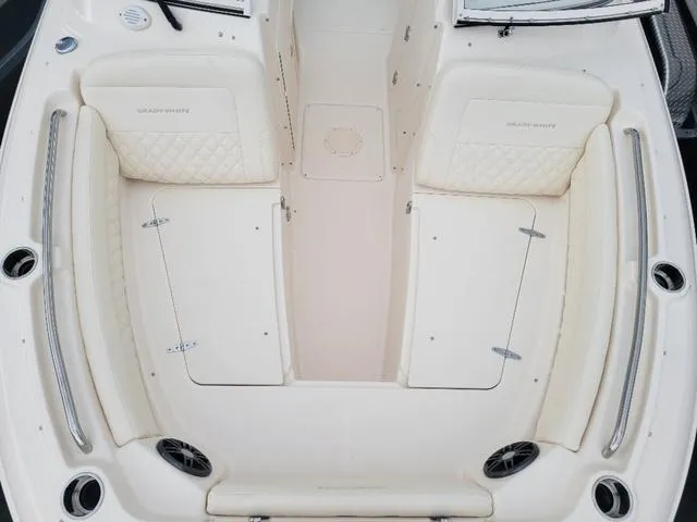 Slide: The Image of 2025 Grady-White Freedom 215 boat interior with cushioned seating and storage compartments. - 17