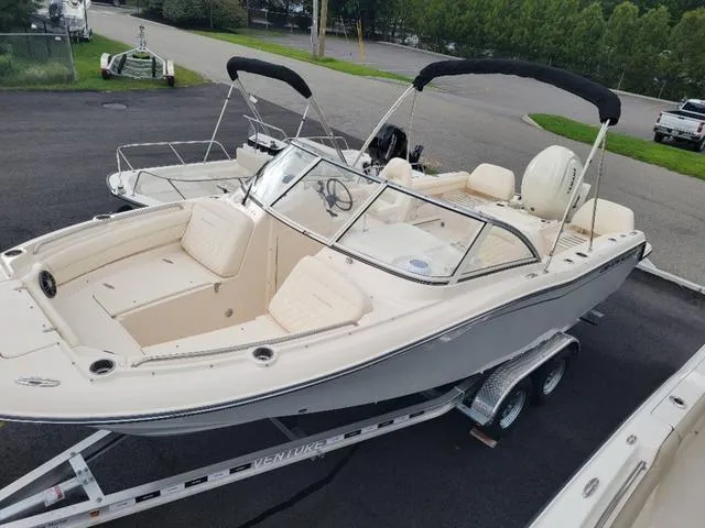 Slide: The Image of 2025 Grady-White Freedom 215 boat on trailer, parked outdoors. - 19