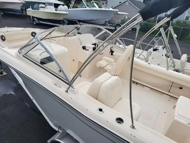 Slide: The Image of 2025 Grady-White Freedom 215 boat, beige interior, dual console, parked outdoors. - 20