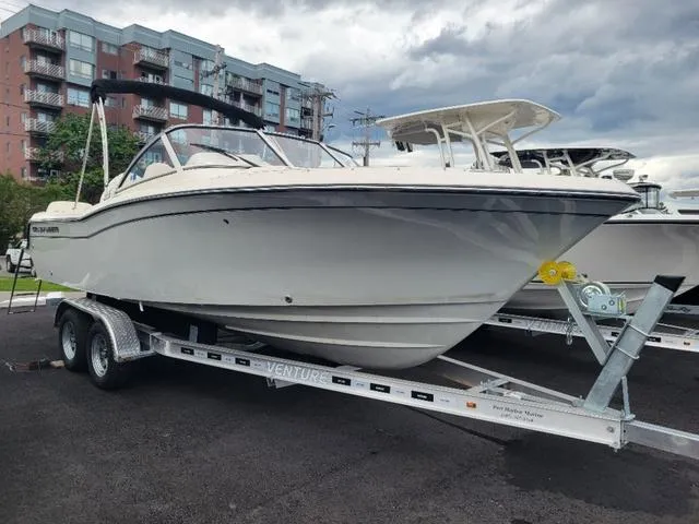 Slide: The Image of 2025 Grady-White Freedom 215 boat on trailer, parked outdoors near buildings. - 3