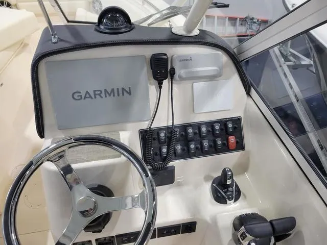 Slide: The Image of 2024 Grady-White Freedom 255 helm with Garmin navigation and control panel. - 12