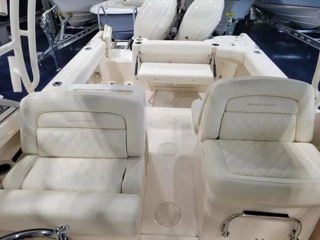 Slide: The Image of 2024 Grady-White Freedom 255 boat interior with plush seating and dual engines. - 14