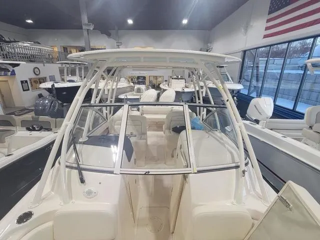 Slide: The Image of 2024 Grady-White Freedom 255 boat in showroom, featuring spacious seating and modern design. - 16