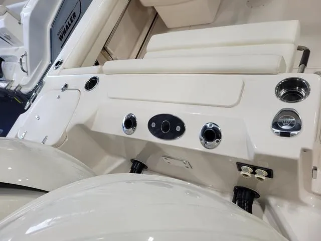 Slide: The Image of 2024 Grady-White Freedom 255 boat interior, featuring control panel and seating area. - 7