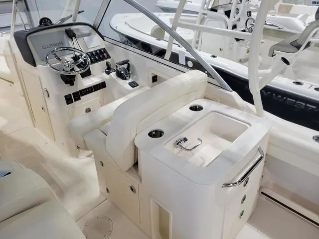 Slide: The Image of 2024 Grady-White Freedom 255 boat interior with helm, seating, and sink. - 8