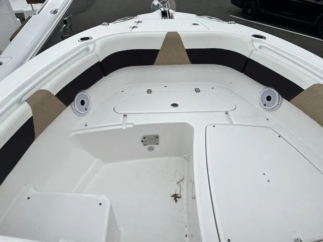 Slide: The Image of 2022 Edgewater 262CX boat interior with seating and storage compartments. - 11