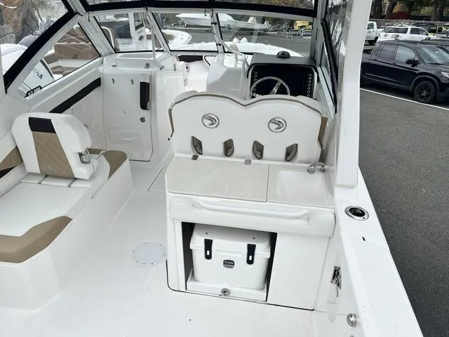 Slide: The Image of 2022 Edgewater 262CX boat interior with seating and storage compartments. - 4