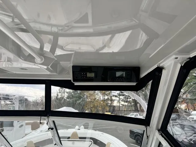 Slide: The Image of Interior view of 2022 Edgewater 262CX boat with electronic controls and panoramic windows. - 9