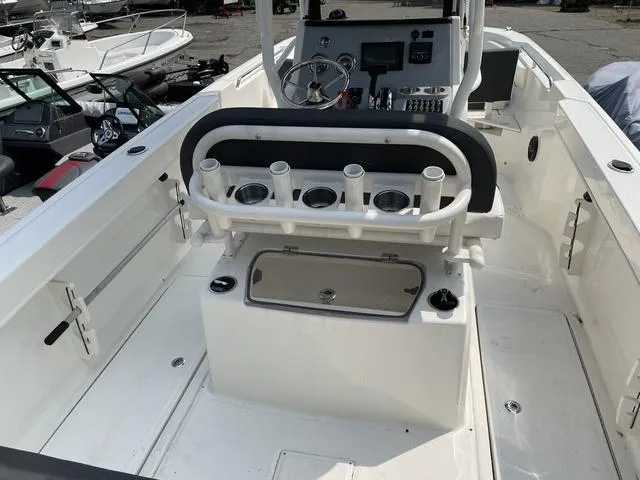 Slide: The Image of 2023 Trophy T 24 CC boat interior with rod holders and console. - 12