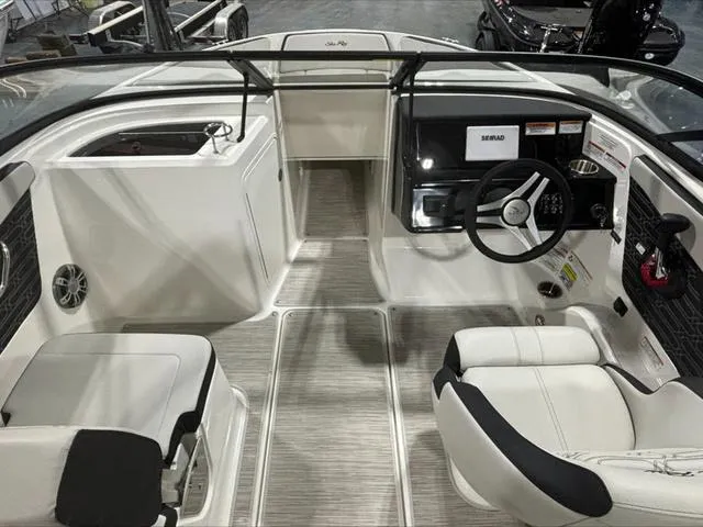 Slide: The Image of 2024 Sea Ray 210 SPX boat interior with modern dashboard and seating. - 3