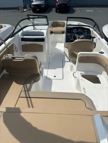 Slide: The Image of 2024 Bayliner VR6 boat interior with beige seating and modern dashboard. - 11