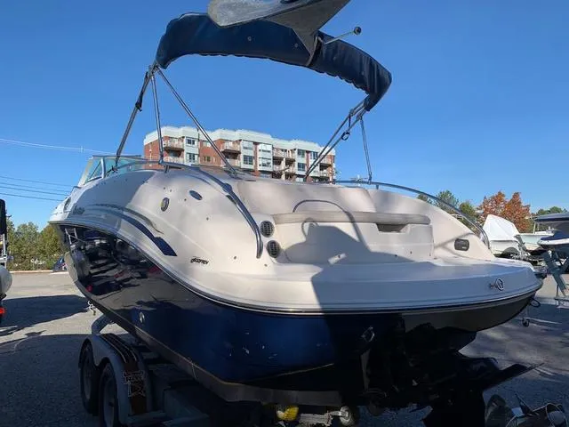 Slide: The Image of 2006 Hurricane 25' DC boat on trailer, blue and white, with bimini top. - 11