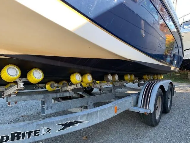 Slide: The Image of 2006 Hurricane 25' DC boat on trailer with yellow rollers, side view. - 13