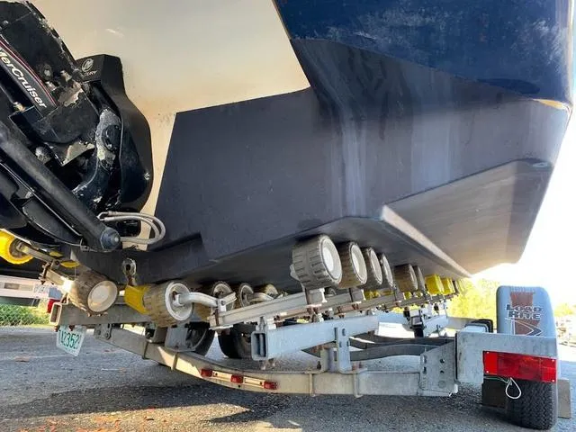 Slide: The Image of 2006 Hurricane 25' DC boat on trailer, rear view showing hull and outboard motor. - 15