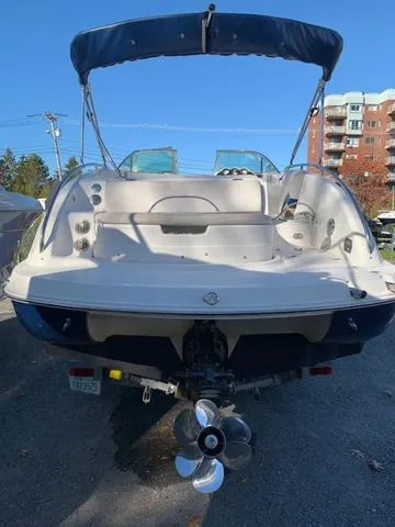 Slide: The Image of 2006 Hurricane 25' DC boat with blue canopy, docked outdoors. - 19