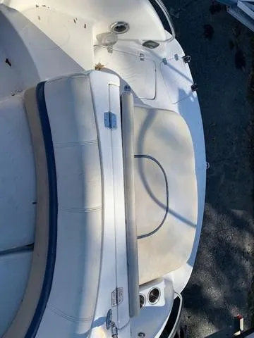 Slide: The Image of 2006 Hurricane 25' DC boat, white seating area, outdoor setting. - 23