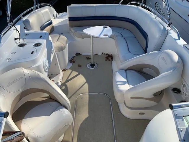 Slide: The Image of 2006 Hurricane 25' DC boat interior with white seating and small table. - 24