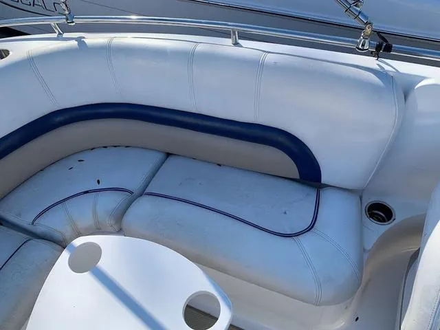 Slide: The Image of 2006 Hurricane 25' DC boat interior with white and blue seating. - 25